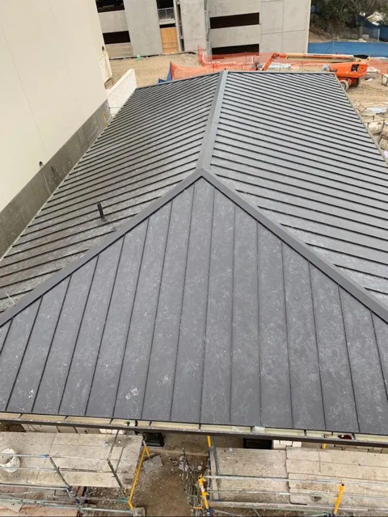 Commercial metal roof construction with crane equipment in Delhi